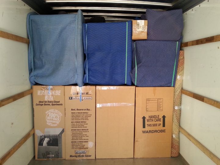 Truck neatly loaded with padded furniture and boxes (Full Service Moving) by Moving Pros CLE