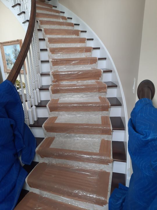 Staircase protected with runners and padded banister (Full Service Moving) by Moving Pros CLE