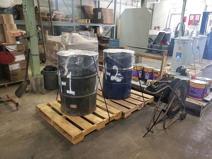 Wrapped drums strapped on pallets in a workshop (Packaging and hauling) by Moving Pros CLE