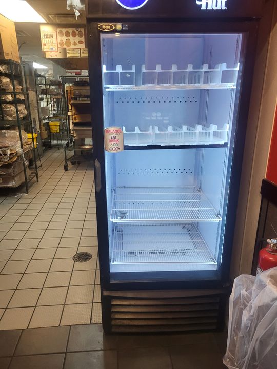 Glass-door commercial refrigerator delivered to a store (Pickup and delivery services) by Moving Pros CLE